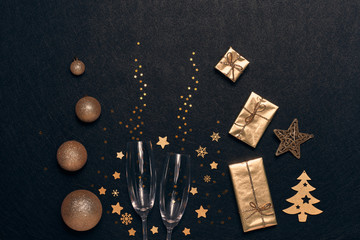 Wall Mural - Christmas and New Year composition with golden  ornaments, gift boxes and empty champagne flutes