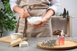 © New Africa - Woman making natural handmade soap over grey stone table, closeup
