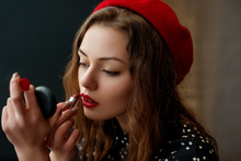 Young Elegant Woman Doing Her Makeup With Red Lipstick