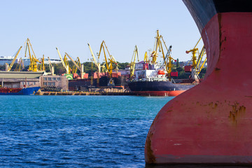 nose of a transport ship with an anchor and mooring ropes