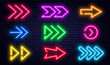 Set of glowing neon arrows. Glowing neon arrow pointers on brick wall background. Retro signboard with bright neon tubes in red, yellow, purple and blue colors