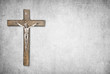 Christian background with crucifix of Jesus Christ on gray distressed concrete wall with copy space