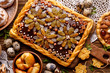 Mazurek pastry, traditional Polish Easter cake made of shortcrust pastry,  chocolate cream, candied fruit, nuts and almonds on the holiday table, top view, close-up. Very sweet dessert, Easter treat