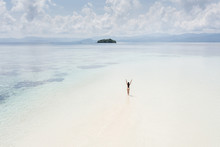 Woman Walking Alone On Amazing Tropical White Sand Beach. Aerial Drone View From Above. Tropical Background And Travel Concept.