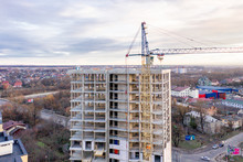 Photo Of A Multi-storey Building Under Construction. Construction Of A Residential Skyscraper. Background Image Of The Process Of Building A House With Cranes. A High-rise Building Under Construction.