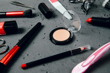 Canvas Print - A set of cosmetics on a dark stone background. The concept of doing makeup, caring for the appearance of women. Applying brushes, eye shadows, powder.