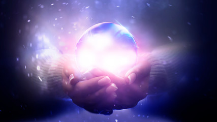 magic particles emanating from female hands. glass ball in the hands. magic particles on the palms, 