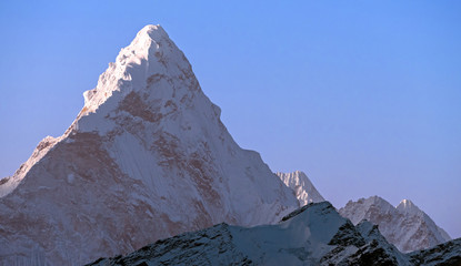 Wall Mural - Triangular pyramid of the majestic Ama Dablam (6814 m) peak on the background of blue sky in Nepal, Himalayan mountains; greatness of nature concept