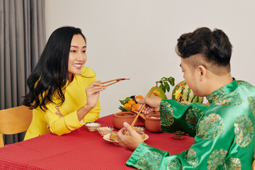 Poster - Romantic young couple having tasty food when celebrating Lunar New Year at home