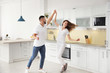 © New Africa - Lovely young couple dancing in kitchen at home