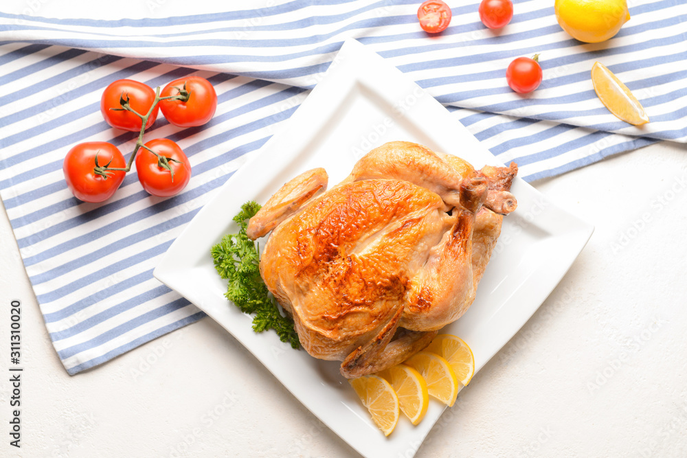 Plate with baked chicken on white background