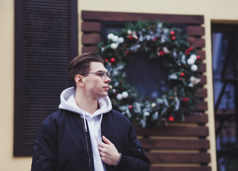 Wall Mural - stylish young man posing in a black jacket