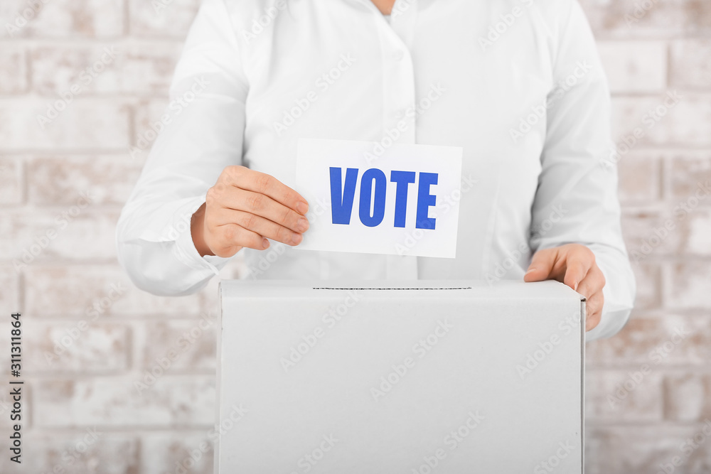 Voting woman near ballot box, closeup