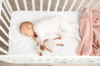 © Pixel-Shot - Cute sleeping little baby in bed