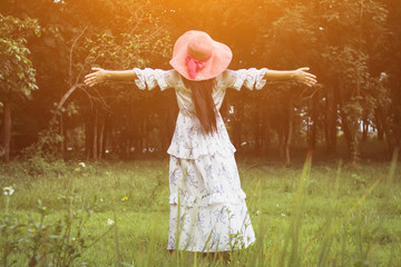 A young girl prayed for God's blessings with the power and holiness of God On the background blurring the sunlight up in the morning.The concept of God and spirituality.