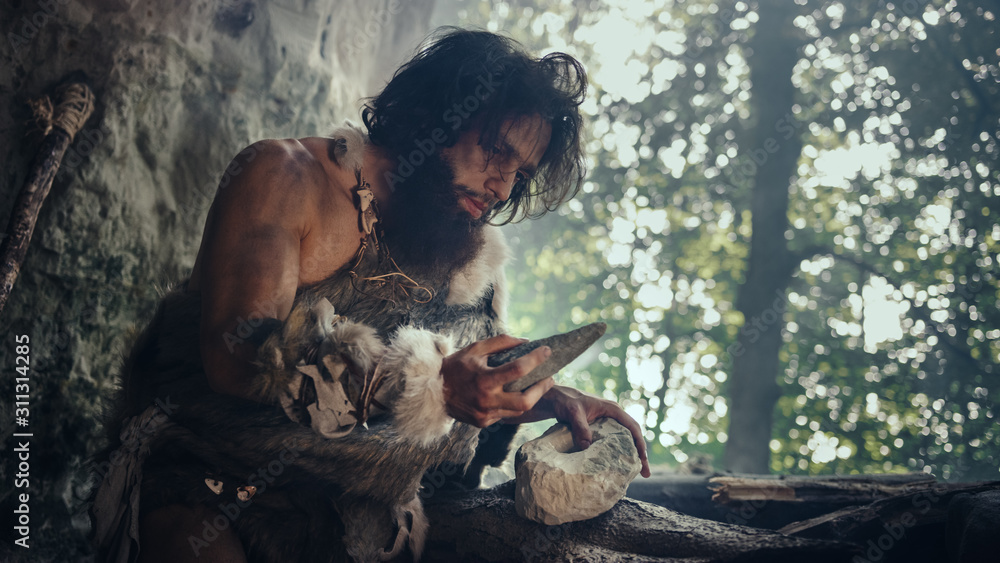Primeval Caveman Wearing Animal Skin Holds Sharp Stone and Makes First Primitive Tool for Hunting Animal Prey, or to Handle Hides. Neanderthal Using Handax. Dawn of Human Civilization - obrazy, fototapety, plakaty 