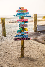 Colourful Signpost Pointing In Different Directions At The Beach On The North Sea