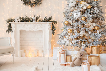 Stylish interior of living room with beautiful Christmas tree and fireplace