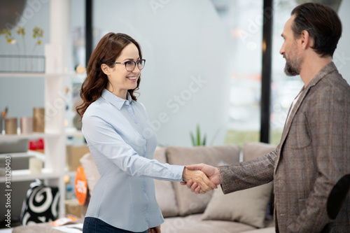 Fotografía Female manager in furniture shop meeting new client