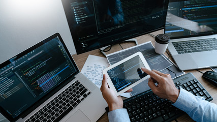 Wall Mural - programmer typing code on desktop computer, developing programming and coding technologies concept.