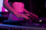 Fototapeta  - DJ mixing in a karaoke bar. Soft focus on hand - a concept of entertainment, youth, entertainment and relaxation
