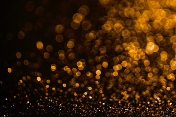 Golden sparkles raster festive background. Bokeh lights with bright shiny effect illustration. Overlapping glowing and twinkling spots decorative backdrop. Abstract glittering circles.