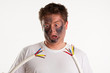 Man extremly surprised by short circuit. He holds wires on white background. His face is smoked. 