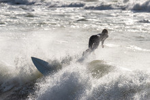 A Surfer Surf A Wave In Italy