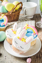 Easter Holiday Greeting Card Background. Cute Homemade Cupcakes With Traditional Easter Bunny, Egg And Springtime Flowers Decor. Happy Easter Concept. Copy Space For Your Text