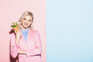 Wall Mural - dreamy woman holding bouquet on pink and blue background