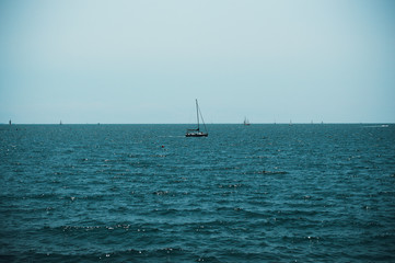 Yachts sail in the sea against the blue sky