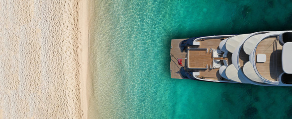 Wall Mural - Aerial drone top view ultra wide photo of luxury yacht docked near exotic sandy turquoise beach
