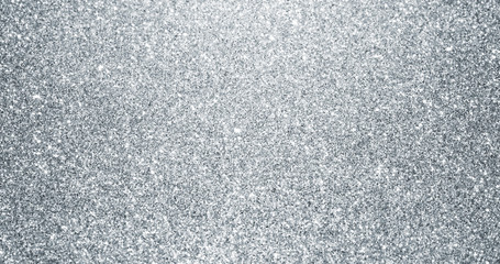 Wall Mural - Silver glitter background with sparkling texture. Silver shimmering light, stars sequins sparks and glittering glow foil background