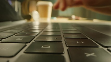 Close-up Macro Shot: Person Opens Laptop Computer and Starts Typing. Focus on Hands and Keybroard. In the Background Sunny Day