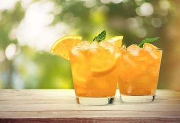 Orange juice and slices of orange fruit in glass