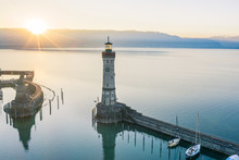 Atmospheric, high-angle view of Lindau Harbour lighthouse at sunrise, Lake Constance, Bavaria, Germany
