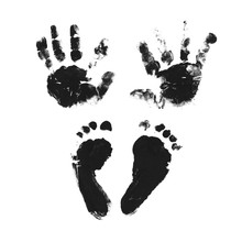 Set Of Hand And Foot Prints. Imprints Of A Four Month Old Baby. Black Paint