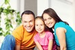 © BillionPhotos.com - Beautiful smiling Lovely family siting on sofa