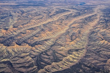 Wall Mural - Colorado Rocky Mountains Aerial panoramic views from airplane of abstract Landscapes, peaks, canyons and rural cities in southwest Colorado and Utah. United States of America. USA.