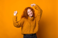 Photo Of Ginger Young Woman, Having Fun And Celebration With Rised Hands, Over Isolated Background