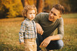 © Vulp - Close up photo of dad with his little boy playing outdoor in park during autumn