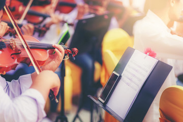 Musician is practicing violin in a music practice classroom prepare for performing violin stage. Concept of practicing violin for professional skills. Selected focus