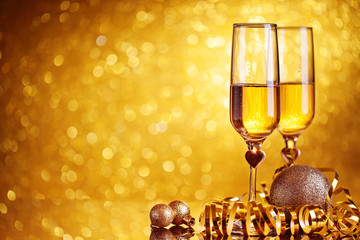 Champagne glasses on a beautiful bokeh background. Happy New Year. Christmas and new year holidays background, winter season. Background with copy space.