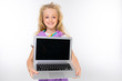 © Ivan Traimak - blond child in a casual look shows a laptop display with a mockup on a white background