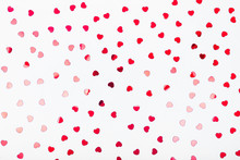 Grey Background With Red Glitter Heart Confetti. Valentine Day Concept. Trendy Minimalistic Flat Lay Design Background. Horizontal