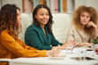 © Seventyfour - Three charming multi-ethnic businesswomen having meeting in board room horizontal shot