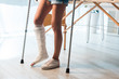 cropped view of fractured woman using crutches to stand in clinic