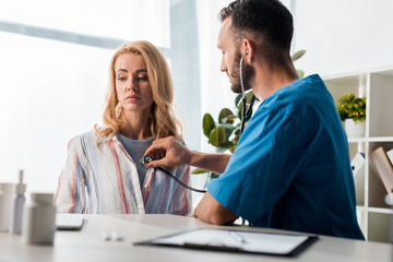 Wall Mural - selective focus of handsome doctor examining woman