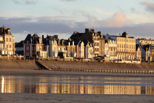Beach In The Evening Sun And Buildings Along The Seafront Promenade In Saint Malo. Brittany, France