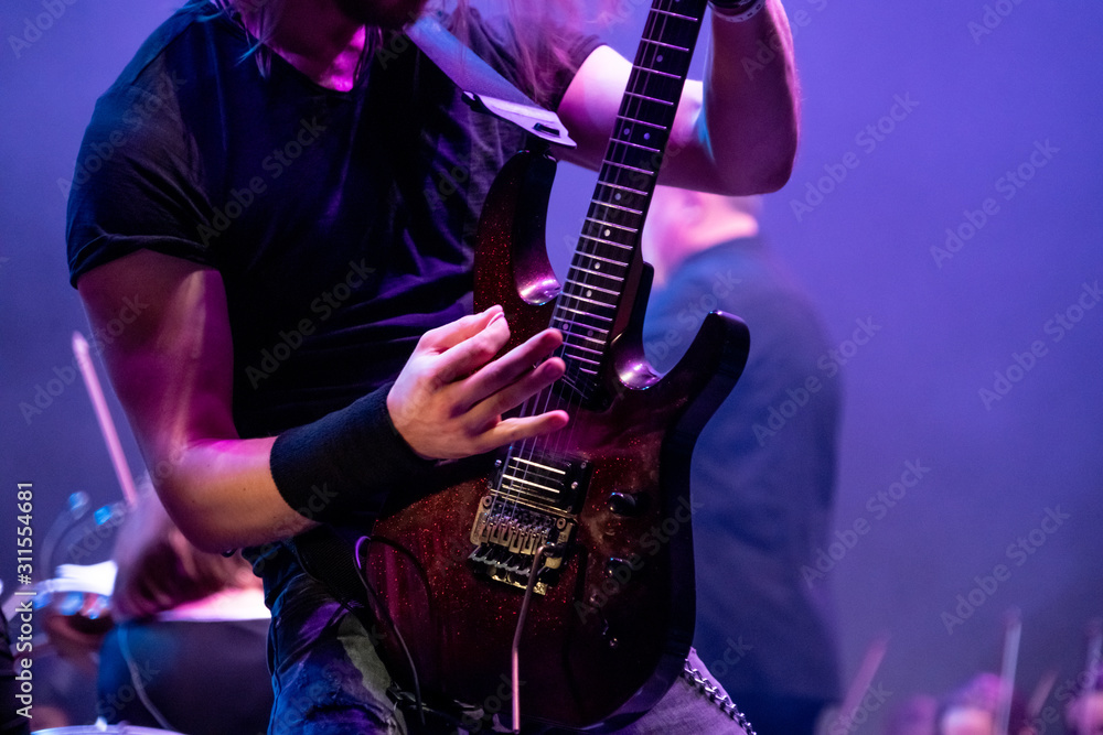 Man playing electric guitar on the stage at the rock concert - obrazy, fototapety, plakaty 